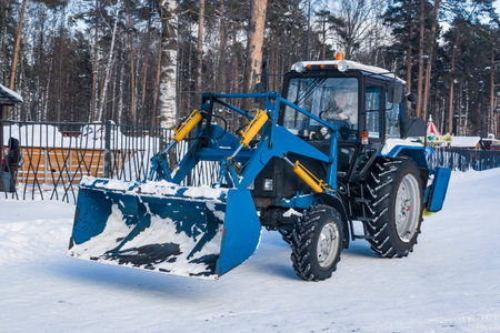City Park, Balashikha, Russia - February 19, 2021. Mechanized cleaning of fallen snow with the help of harvesting equipment.のeditorial素材