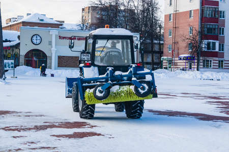 City Park, Balashikha, Russia - February 19, 2021. Mechanized cleaning of fallen snow with the help of harvesting equipment.のeditorial素材