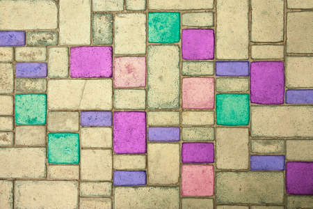 Multi-colored paving slabs are laid in smooth neat rows. Close-up background.