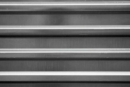 Realistic metal texture. Polished background made of galvanized steel. Sheet of profile rolled metal. Close-up background.の写真素材