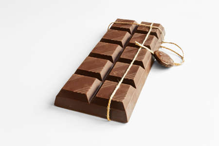 Chocolate. Exquisite chocolate bar close-up. On a white background.の写真素材