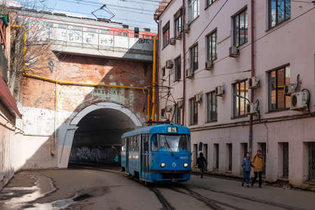 Central District, Moscow, Russia - March 28, 2021. Moscow tram. Urban electric transport in Moscow. The modern Moscow tram passes through the arch.のeditorial素材