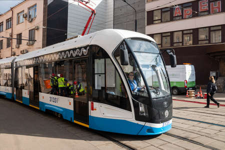 Central District, Moscow, Russia - March 28, 2021. Moscow tram. Urban electric transport in Moscow. The modern Moscow tram passes through the arch.のeditorial素材