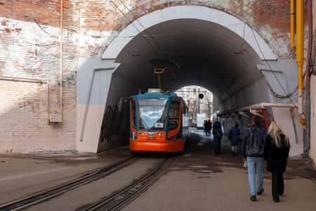 Central District, Moscow, Russia - March 28, 2021. Moscow tram. Urban electric transport in Moscow. The modern Moscow tram passes through the arch.のeditorial素材