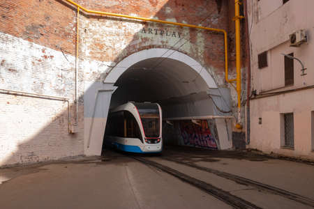 Central District, Moscow, Russia - March 28, 2021. Moscow tram. Urban electric transport in Moscow. The modern Moscow tram passes through the arch.のeditorial素材
