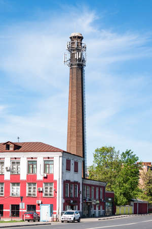 Balashikha, Cotton Spinning factory - May 09, 2018. The chimney of a cotton mill. The chimney is an atmospheric pollutant. Pipe emissions pollute the environment.のeditorial素材
