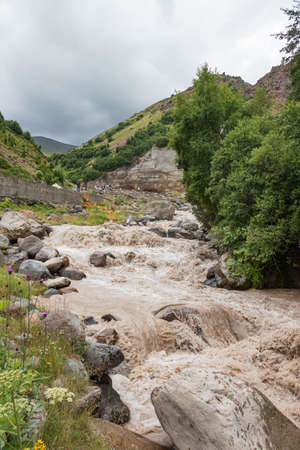 Close-up of a large turbulent flow of water in the river. A mountain river carries its waters posing a danger to careless actions. Gila-Su tract, Elbrus region, Kabardino-Balkaria, Russia.の写真素材