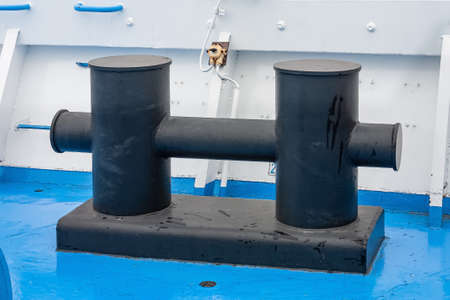 A bollard made of corrosion-resistant steel is installed on the pier of the seaport.