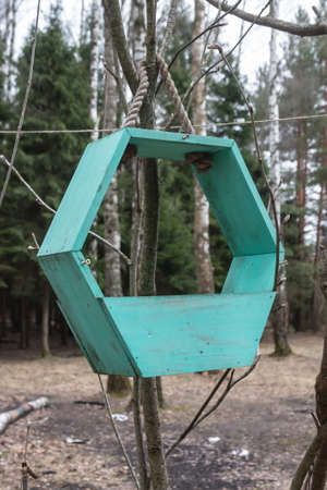 Wooden bird feeder birdhouse on a tree in the forest. Birdhouse close-up.の写真素材