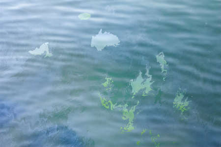 A large abstract stain from the spilled surface of the sea of motor oil or gasoline. Marble abstract background.の写真素材