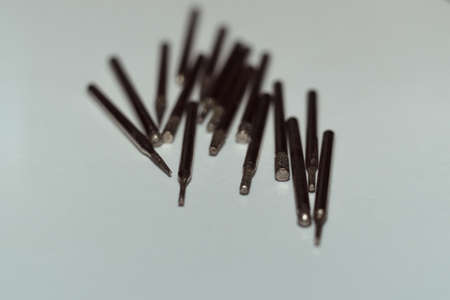 Diamond drill bits on white background. Close-up view. Tools jeweler and dentist.