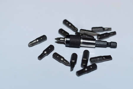 Many tool bits with bitholder on white background.