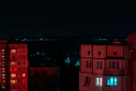 Long exposure photo of high-rise buildings in red and blue lights.の写真素材
