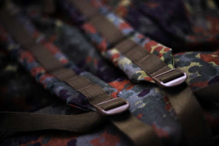 Military camouflage roomy backpack. In the frame of the strap and the back of a backpack. Close-up view.の写真素材