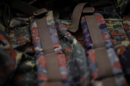 Military camouflage roomy backpack. In the frame of the strap and the back of a backpack. Close-up view.の写真素材