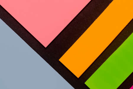 Blue, orange, green and rose hue colorful office stickers on black paper. Office noteparer as reminder. Isolated on black paper.の写真素材