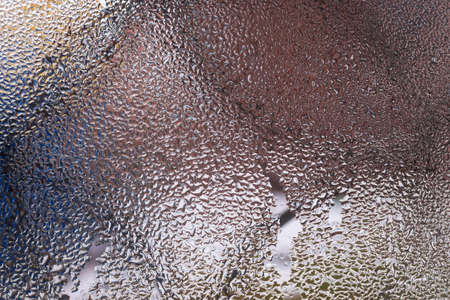 Water drops on glass window close up with blurred background. Drops in macro. Condensate on window...