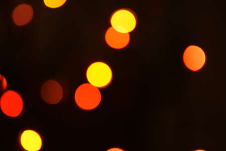 Multi-color holiday garland. Garland is blurred. Many colorful round lights. Fully defocused photo....