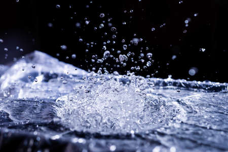 Water drops splashing on acoustic membrane. A lot of drops in air. High frequency of sound waves....