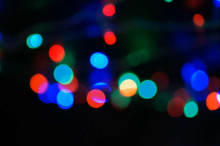 Multi-color blue holiday garland. Garland is blurred. Many big colorful round lights. Fully...