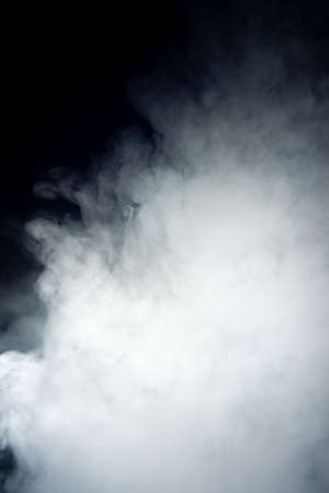 Ð¡louds of vape fog on black background. At right side thick smoke rising up. Vape culture and no...