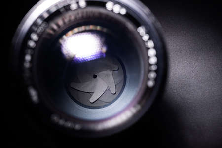 Vintage lens aperture closeup. Stock photo with blurred foreground.の写真素材