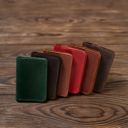Six two-pocket leather handmade cardholder. Cardholders lies one on another. Stock photo on blurred...