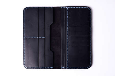Two handmade black leather porte-monnaie isolated on white background. Stock photo of luxury...
