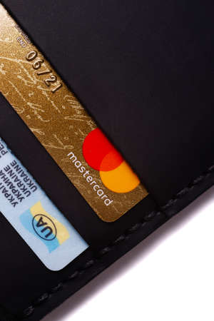 24.01.2019 Ukraine, Kyiv. A part of handmade black leather wallet isolated on white background...