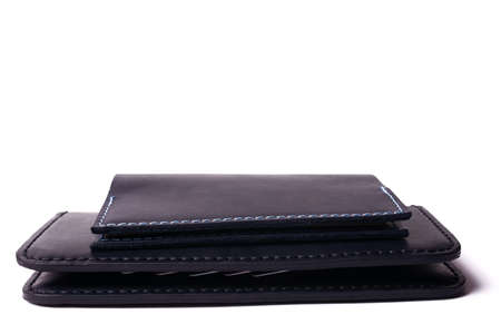 Black handmade leather man wallet and passport cover isolated on white background. Purse and cover are closed. Stock photo of luxury businessman accessories.の写真素材