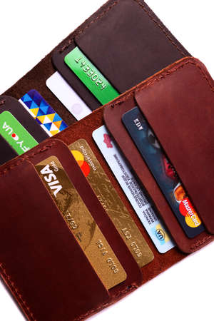 24.01.2019 Ukraine, Kyiv. A part of handmade red and brown color leather cardholders isolated on...