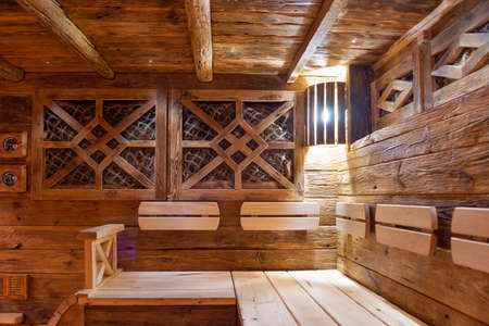 Handmade bath in the spa complex. The bath is trimmed with planks and hay.の写真素材