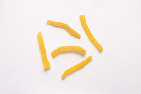 Candied cantaloupe pieces isolated on white backgroud.