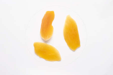 Candied mango slices isolated on white backgroud.の写真素材
