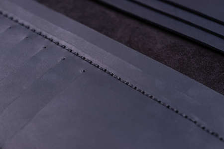 Dark blue handmade leather wallet details closeup. Pockets for cards, hue picture.