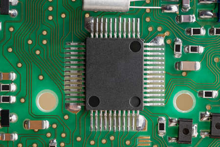 PCB board supermacro close-up. Many capacitors, resistors on board. Digital engineering photo. Flash...
