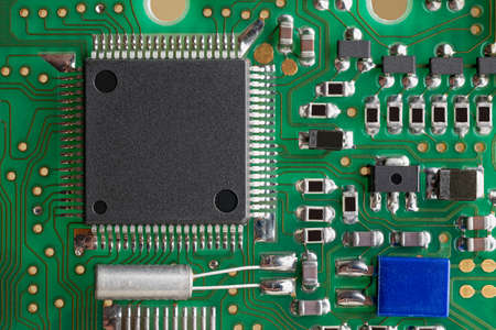 PCB board supermacro close-up. Many capacitors, resistors on board. Digital engineering photo. Flash...