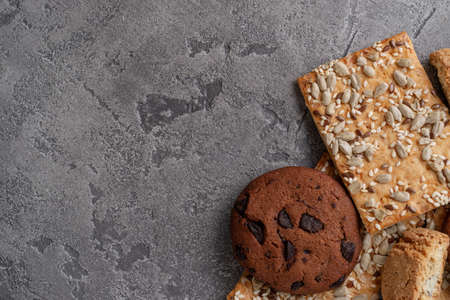 Cookies with cereal and sunflower seeds. Dark cookies with chocolate in right down corner. Many...