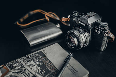 Retro Camera With Notebook On Dark Backgroundの写真素材