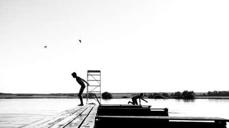 Children bathe in the lake,Children jumping into the lake,carefree childhoodの写真素材