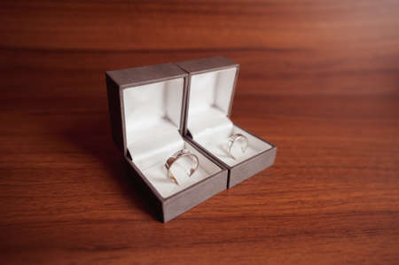 wedding rings white gold in boxes on wooden tableの写真素材