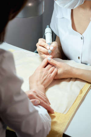 A professional technician grinding machine, nail polish, professional nail care handの写真素材