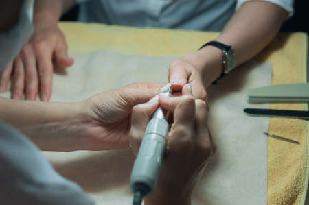 A professional technician grinding machine, nail polish, professional nail care handの写真素材