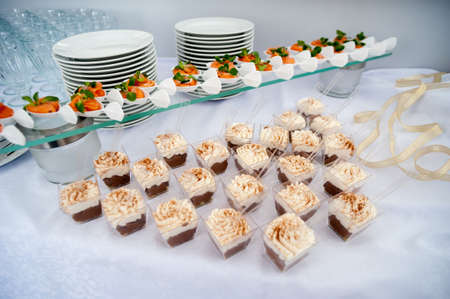 beautiful candy bar serving a festive table with cupcakes towers and sweet love signの写真素材