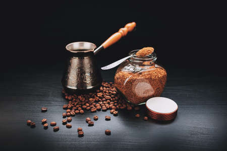 black coffee, coffee beans, instant fast on a black background, with the Turks for brewing coffee and the glass jar of instant coffee quicklyの写真素材
