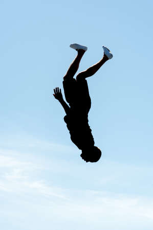 A man is jumping on a trampoline Against the blue sky, Design element.