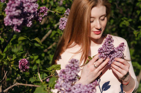 Beautiful woman with flowers of lilac Skincareの写真素材