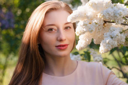 Beautiful woman with flowers of lilac Skincareの写真素材