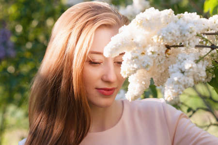 Beautiful woman with flowers of lilac Skincareの写真素材