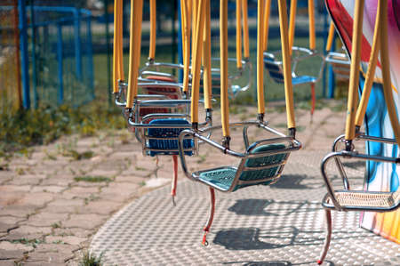 Summer playground in the park, swing carousel without peopleの写真素材